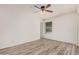 Neutral bedroom with a ceiling fan, window view, and wood-look vinyl flooring at 870 S Palm Ln # 55, Chandler, AZ 85225