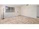 Bright bedroom features tile floors, a window, and a door for ample natural light and accessibility at 870 S Palm Ln # 55, Chandler, AZ 85225