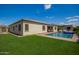 Beautiful backyard view featuring a pristine pool, artificial grass, and an immaculate exterior at 9281 W Villa Chula --, Peoria, AZ 85383