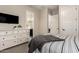 This bedroom features a dresser with television and access to bathroom at 9281 W Villa Chula --, Peoria, AZ 85383