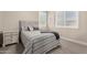 Comfortable bedroom boasts a quilted bed, bedside tables, and shuttered windows at 9281 W Villa Chula --, Peoria, AZ 85383