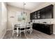 Charming dining area with a modern chandelier and a built-in coffee bar with stylish cabinetry at 9281 W Villa Chula --, Peoria, AZ 85383