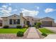 Charming single-story home with a tiled roof, manicured lawn, and brick pathway at 9281 W Villa Chula --, Peoria, AZ 85383