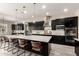 Contemporary kitchen boasts a large island, stainless steel appliances, and elegant pendant lighting at 9281 W Villa Chula --, Peoria, AZ 85383