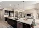 Modern kitchen with a large island and stainless steel appliances seamlessly connects to the living room at 9281 W Villa Chula --, Peoria, AZ 85383