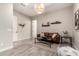 Cozy living room with a comfortable leather couch, stylish decor, and gray wood-look tile floors at 9281 W Villa Chula --, Peoria, AZ 85383