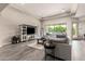 Spacious living room featuring a large window, modern tile flooring, and a stylish entertainment center at 9281 W Villa Chula --, Peoria, AZ 85383
