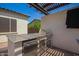 Outdoor kitchen featuring built-in grill and stainless steel refrigerator set into a functional island at 9281 W Villa Chula --, Peoria, AZ 85383