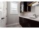 Practical wet bar with dark cabinetry, a bright white countertop, and matching tile floor at 9281 W Villa Chula --, Peoria, AZ 85383