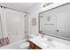 Bathroom features a shower-tub combination and a wooden vanity with a bright mirror at 1215 W Wahalla W Ln, Phoenix, AZ 85027