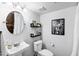 Charming bathroom featuring pedestal sink and unique wall decor at 1215 W Wahalla W Ln, Phoenix, AZ 85027