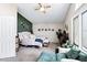 Bright bedroom with plants, a ceiling fan, and ample space for relaxation at 1215 W Wahalla W Ln, Phoenix, AZ 85027