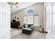 Bedroom with vaulted ceiling, large windows, and a comfortable chaise lounge chair at 1215 W Wahalla W Ln, Phoenix, AZ 85027