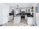 Bright kitchen with white cabinets, stainless steel appliances, black countertops, and a charming center island at 1215 W Wahalla W Ln, Phoenix, AZ 85027
