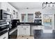 Updated kitchen featuring white cabinets, black countertops, stainless appliances, and views to the swimming pool at 1215 W Wahalla W Ln, Phoenix, AZ 85027