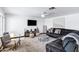 Spacious living room with a plush gray sectional, area rug, fan, and large screen tv at 1215 W Wahalla W Ln, Phoenix, AZ 85027