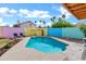 Inviting pool surrounded by a colorful privacy fence, lush greenery and ample space for outdoor lounging at 1215 W Wahalla W Ln, Phoenix, AZ 85027