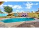 Beautiful pool area with lounge chairs and a colorful privacy fence creating a tranquil outdoor oasis at 1215 W Wahalla W Ln, Phoenix, AZ 85027