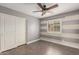 Bedroom with ceiling fan, horizontal color bands and closet with doors at 14208 W Larkspur Dr, Surprise, AZ 85379