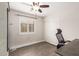 Bedroom with wood floor, window with plantation shutters, closet with sliding doors, and ceiling fan with light at 14208 W Larkspur Dr, Surprise, AZ 85379