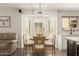 Cozy dining area with a bay window, neutral decor, and convenient access to the kitchen at 14208 W Larkspur Dr, Surprise, AZ 85379