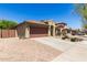 Lovely single-Gathering home showcasing a clay tile roof, desert landscaping, and a spacious three-car garage at 14208 W Larkspur Dr, Surprise, AZ 85379