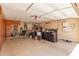 Spacious garage with storage cabinets, wall-mounted Tesla power charger, and overhead lighting at 14208 W Larkspur Dr, Surprise, AZ 85379