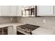 Well-appointed kitchen with stainless steel appliances, sleek countertops, and stylish backsplash at 14208 W Larkspur Dr, Surprise, AZ 85379