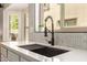 Bright kitchen featuring modern sink fixtures, counter space, and light backsplash at 14208 W Larkspur Dr, Surprise, AZ 85379