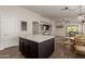 Open concept living area includes kitchen island, kitchen access, and living room seating at 14208 W Larkspur Dr, Surprise, AZ 85379
