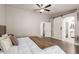 This well-lit bedroom features wood floors, a sliding barn door to the bathroom and a closet at 14208 W Larkspur Dr, Surprise, AZ 85379
