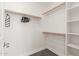Walk-in closet with shelves and hanging rods at 14208 W Larkspur Dr, Surprise, AZ 85379