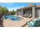 Inviting backyard with a sparkling pool, relaxing lounge chairs, and a shaded patio, creating an ideal outdoor living space at 14801 S 8Th St, Phoenix, AZ 85048