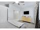 Bright bedroom with a TV, dresser, ceiling fan, and ample closet space, creating a functional and inviting space at 14801 S 8Th St, Phoenix, AZ 85048