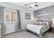 Cozy bedroom featuring plush carpeting, ceiling fan, and an upholstered headboard with neutral tones for a relaxing ambiance at 14801 S 8Th St, Phoenix, AZ 85048