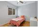 Well-lit bedroom with hardwood floors, featuring a single bed and a clean, minimalist decor for a cozy retreat at 14801 S 8Th St, Phoenix, AZ 85048