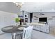Bright dining area featuring a round table, white chairs, and view to open kitchen at 14801 S 8Th St, Phoenix, AZ 85048