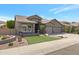 Beautiful home with a manicured lawn, desert landscaping, and a spacious driveway under a sunny sky at 14801 S 8Th St, Phoenix, AZ 85048