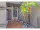 Welcoming front porch with tiled flooring, a wrought iron security door, and desert landscaping accents at 14801 S 8Th St, Phoenix, AZ 85048