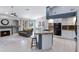 Open kitchen with island and granite counters flowing into a living area with fireplace at 14801 S 8Th St, Phoenix, AZ 85048