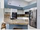 Modern kitchen featuring granite countertops, stainless steel appliances, and white cabinetry at 14801 S 8Th St, Phoenix, AZ 85048