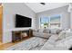 Cozy living room with a fireplace, a comfortable sectional sofa, and large windows for natural light at 14801 S 8Th St, Phoenix, AZ 85048