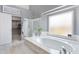 Luxurious main bathroom with soaking tub, walk-in shower, and walk-in closet at 14801 S 8Th St, Phoenix, AZ 85048