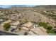 Beautiful aerial view of homes in a desert community with mountain views and sparkling blue pools at 15020 S 25Th St, Phoenix, AZ 85048