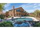 Inviting backyard with a sparkling pool and spa, a covered patio, and lush landscaping for a private retreat at 15020 S 25Th St, Phoenix, AZ 85048