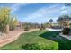 Spacious backyard with a well-maintained lawn, desert landscaping, and secure fencing for privacy at 15020 S 25Th St, Phoenix, AZ 85048