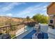 Inviting balcony with plush seating overlooking desert, pool and lush landscaping at 15020 S 25Th St, Phoenix, AZ 85048