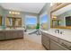 Luxurious bathroom featuring dual vanities, garden tub, mountain views, and stylish fixtures for relaxation and comfort at 15020 S 25Th St, Phoenix, AZ 85048