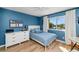 Comfortable bedroom with blue walls, hardwood floors, and a bright window view at 15020 S 25Th St, Phoenix, AZ 85048