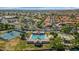 Aerial view of a community pool, tennis courts, green space and neighborhood at 15020 S 25Th St, Phoenix, AZ 85048